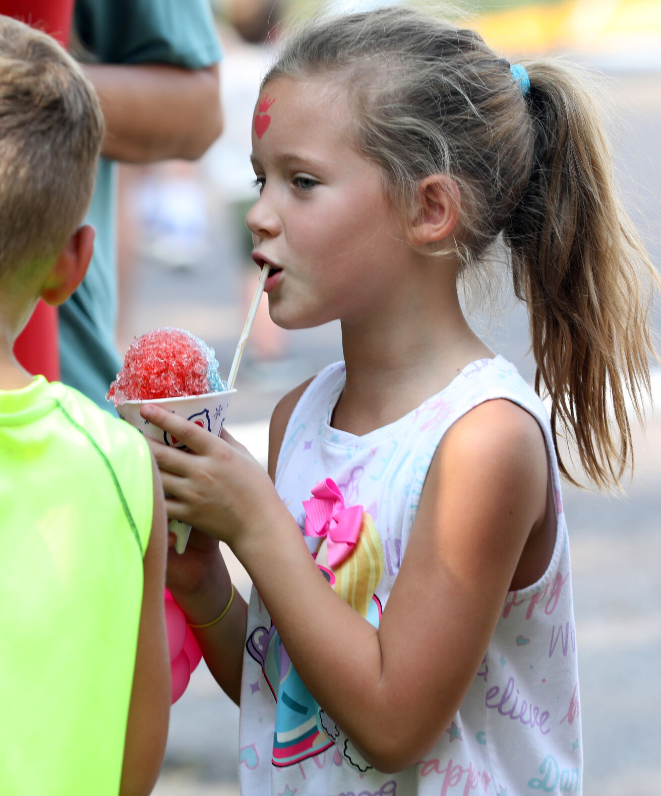 Quinn Burton sips on a snow cone